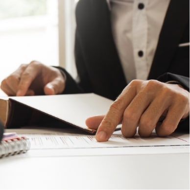 Photographie illustrant une personne qui vérifie la conformité réglementaire d'un document